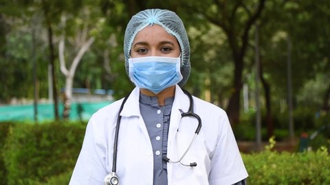 Portrait of Medical doctor wears protection mask and stethoscope, standing self confident with crossed hands