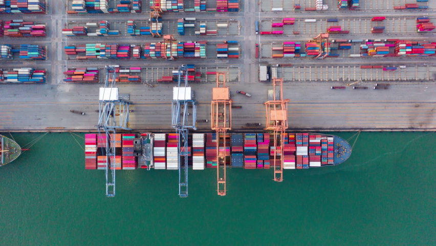 Container ship in export and import business and logistics. Shipping cargo to harbor by crane. Water transport International. Aerial view and top view. Royalty-Free Stock Footage #1079491142