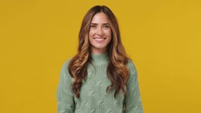 Smiling charming fascinating young brunette woman 30s years old wears mint sweater looking camera wink eye blink isolated on plain yellow background studio portrait. People emotions lifestyle concept - Powered by Shutterstock - Get 15% off with code: PIKWIZARD15