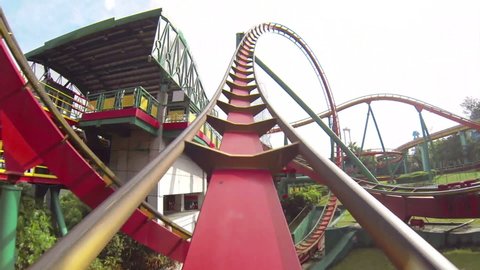 pov shot of twisting red and yellow roller coaster
