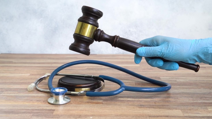 someones hand with law gavel in hand, medical law concept