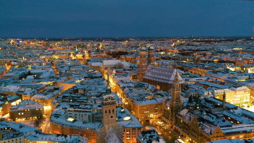 Munich aerial skyline view at night with snow winter time christmas, fly over marienplatz sqaure
frauenkirche church and town hall, munich night drone video birds view.