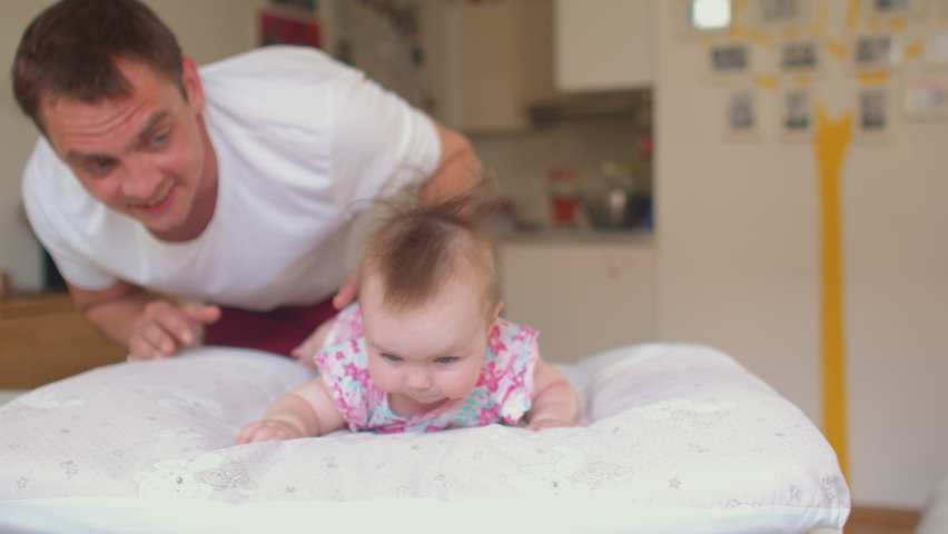 Tummy time gives your baby the chance to try a new position and helps prevent them getting a flat spot on their head from lying on their back so much. Measures reduce gas and colic risk in babies.  Royalty-Free Stock Footage #1079501465