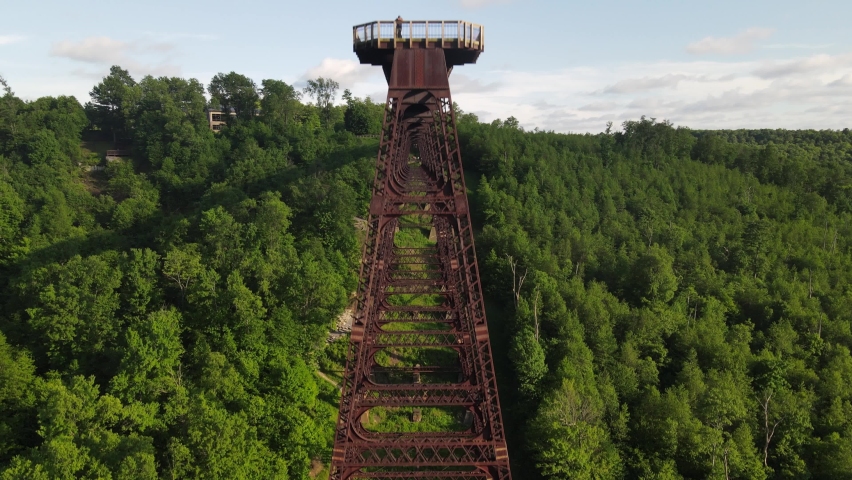 Antique wooden train tracks at Kinzua Bridge State Park in Pennsylvania in the Allegheny National Forest drone front of bridge shot.