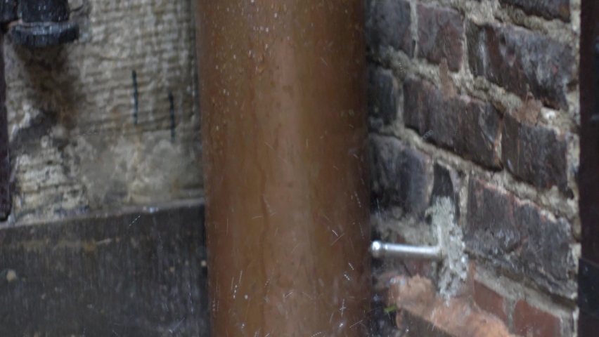Water Splashing Out of Gutter Downspout During Heavy Rainfall Royalty-Free Stock Footage #1079521157
