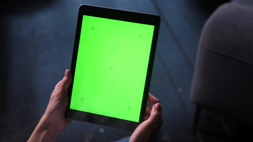 Closeup shots of green screen on iPad. Female person holds in hands portable tablet computer with moving green motion tracking points. Touching device screens surface with fingers, swiping and zooming | Shutterstock HD Video #1079524700