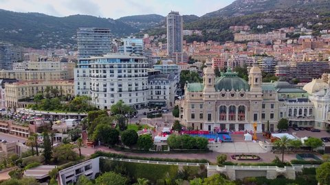 Aerial view of the old casino. area with palm trees. Luxurious super cars in front of the hotel. Monument and fountain. Modern architecture of the kingdom of MONTE CARLO, MONACO SEPTEMBER 2021 