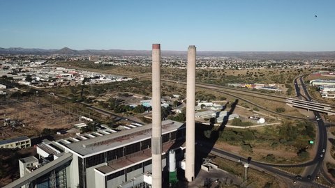 Windhoek, Namibia, 05.02.20: 4K bright summer morning aerial video of Van Eck coal-fired power station and its chimneys located in Windhoek Northern Industrial area, Khomas Region, southern Africa