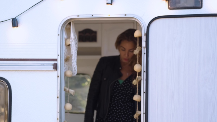 stylish rock woman peeking out of the camper