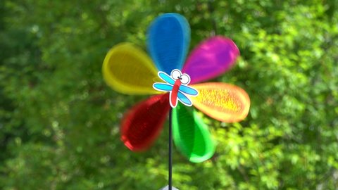 air vane with multicolored blades turns from the wind. 