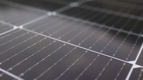 View from the camera moving next to the solar panels. Close-up of modern photovoltaic solar battery panels. Solar panel, photovoltaic, alternative electricity source. Efficient ecological solar farm.