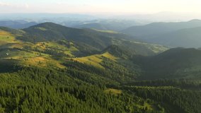 Drone flying over a mountains and green forest. Bird's eye view. Location place Carpathian mountains, Ukraine, Europe. Cinematic aerial shot. Discover the beauty of world. Filmed in 4k, drone video.