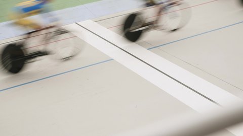 Velodrome. Cycling track finish line. Group of professional cyclists crossing finish line at bicycle competition. Open cycling track. Training on velodrome, men riding fixed gear bicycles