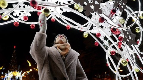 Young woman walks in the park with Christmas garlands at night. New Year, garlands, holiday, happy girl