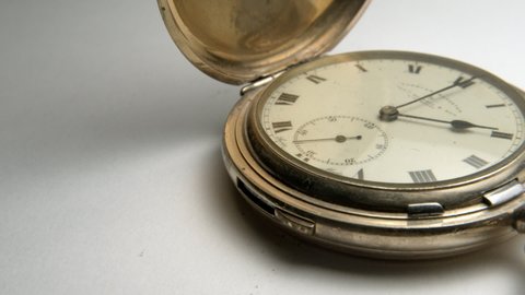 Antique pocket watch ticking packshot slow pan