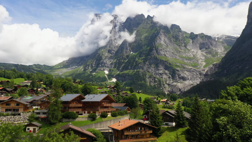 Cinematic drone shot flying over buildings in Grindelwald, in Switzerland’s Bernese Alps.