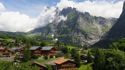 Cinematic drone shot flying over buildings in Grindelwald, in Switzerland’s Bernese Alps.