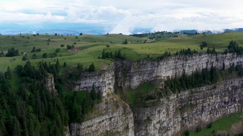 Rotating drone shot of Creux du Van in Switzerland, located at the border of the cantons of Neuenburg and Vaud