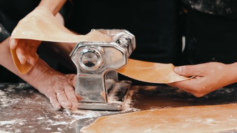 Footage of chef in kitchen preparing dough with machine for pasta and lasagna
