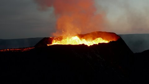Fly around volcano crater during molten magma eruption. Stream of hot lava running off down. Fagradalsfjall volcano. Iceland, 2021