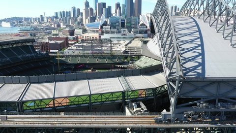Seattle , WA , United States - 06 20 2021: Cinematic 4K aerial drone trucking video of the T-Mobile ballpark roof structure with Seattle downtown in the background