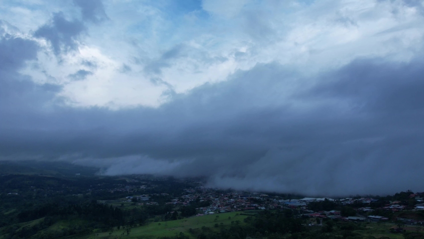 is getting dark, clouds are coming to the city!