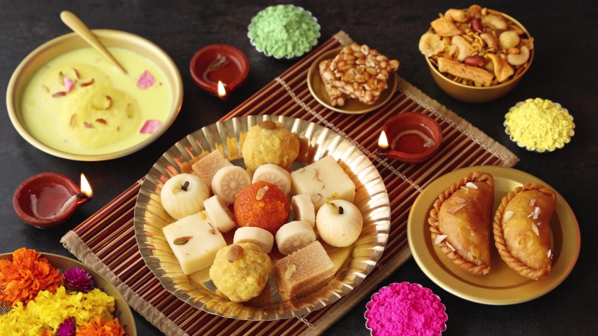 Women hand taking mix of Indian sweet food specially made for festivals of India like Diwali Gujiya peda barfi Indian sweet dessert mithai festival Dussehra Holi Ganesh Chaturthi Ram Navami Durga | Shutterstock HD Video #1079566787