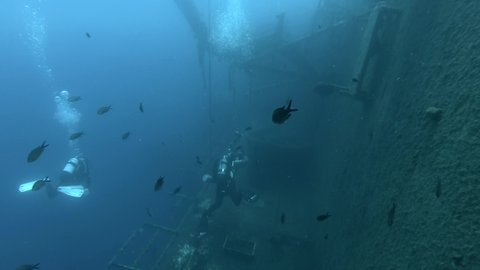 MEDITERRANEAN SEA, CYPRUS - AUGUST, 2021: Scuba divers swims on the shipwreck Swedish ferry MS Zenobia. Wreck diving. Mediterranean sea, Cyprus
