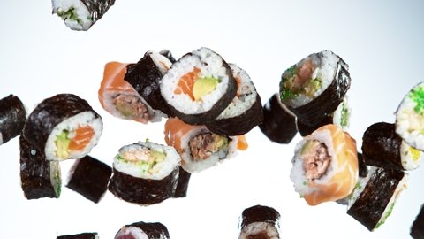 Super slow motion of flying sushi pieces on white background. Filmed on high speed cinema camera, 1000fps