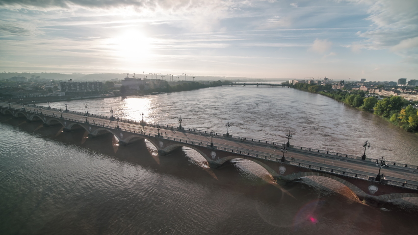 Establishing Aerial View Shot of Bordeaux Fr, Pont de Pierre, world capital of wine, Nouvelle-Aquitaine, France, flying along the bridge