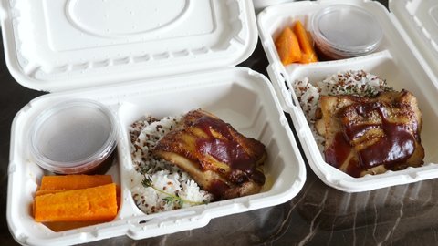 Healthy Food Delivery in White Recycling Paper Eco Boxes. Fitness Dinner with Chicken, No Sugar Sauce, Rice and Quinoa. Concept of Takeaway Diet Food from Restaurant or Delivering Due Quarantine