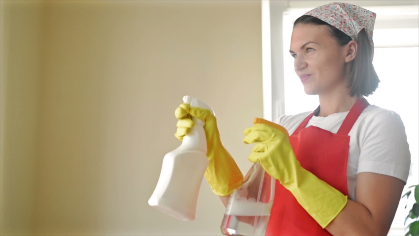 Tired of boring work, the housewife started a fun game with the Hand Sprayers. | Shutterstock HD Video #1079577728