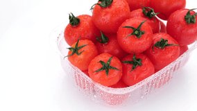 Fresh red tomatoes in container for delivery or sale on white background. 4K UHD video 