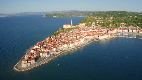 4k drone flight moving to the side footage (Ultra High Definition). Stunning morning cityscape of Piran. Amazing summer scene of Slovenia’s Adriatic coast. Mediterranean seascape.