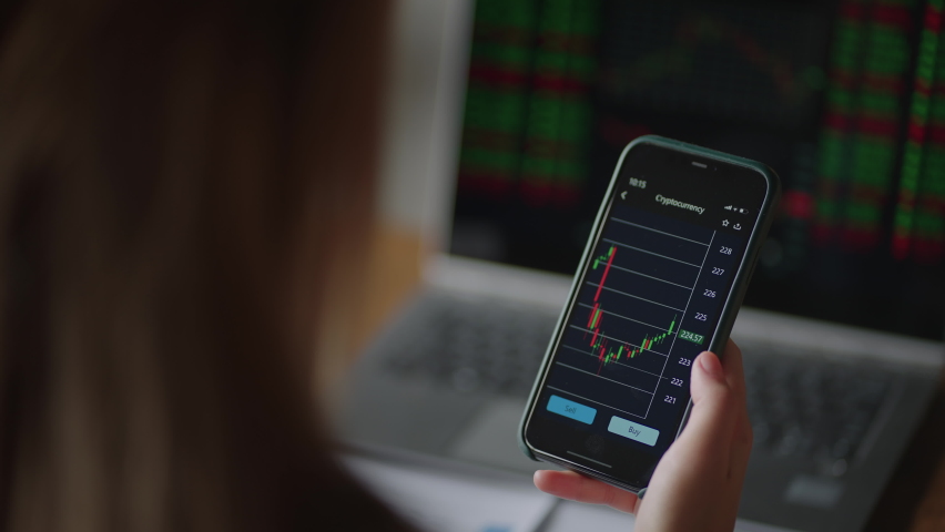 Investor Checking Stock Market Data On Screen Mobile Phone. Asian woman trading stock market on smart phone with stock market financial screen. cryptocurrency price chart on a of a smartphone screen | Shutterstock HD Video #1079593925