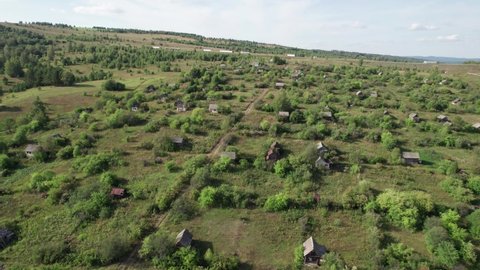 Aerial Landscape: summer mountain village with forests, fields, human settlement in Bashkortostan. Majestic landscape.