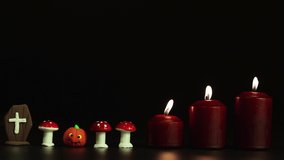 Tombstone, toadstools with pumpkin and candles, Halloween horror story. Isolated image on black background, copy space. Video, footage or background for splash screen, credits, cutouts, intro. UHD 4K.