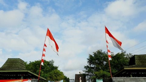 Yogyakarta, Indonesia, on September 3, 2021, two large red and white flags, the Indonesian flag, fluttered at the entrance of the Plataran monument, to commemorate Indonesia's independence day