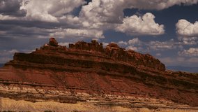 Dreamy cumulus clouds float above the San Rafael Swell, Utah on an idyllic summer day. - Powered by Shutterstock - Get 15% off with code: PIKWIZARD15