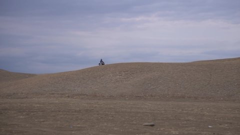 the biker are riding motorcycle on mountain