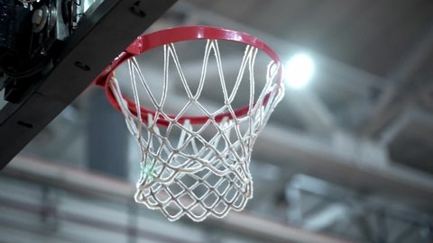Basketball hits the basket by hitting the net in slow motion EDITORIAL