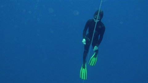 free divers training on the buoy, slow motion. Freediving is a sport when a person dives into sea water while holding his breath. An extreme type of underwater diving to a depth without professional