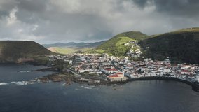 Sao Jorge island, Azores, Portugal. Drone footage of the peninsula and a sunrise over it. Charming island with traditional coastal architecture. High quality 4k footage