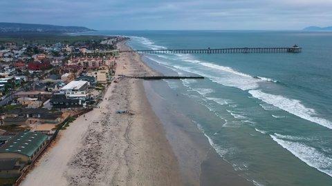 Scenic vibrant view of Imperial Beach Pier, with Playas de Tijuana Mexico and the Coronado Islands in distance, drone perspective 