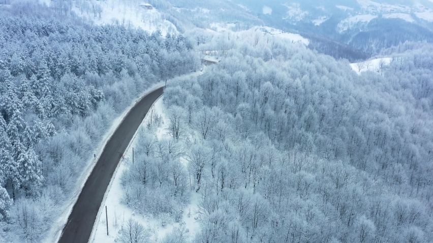 Winter road and snow covered trees in the forest. Aerial, scenic winter mountain landscape of Bolu, Kartepe Country in Turkey. Fly over, Tracking
