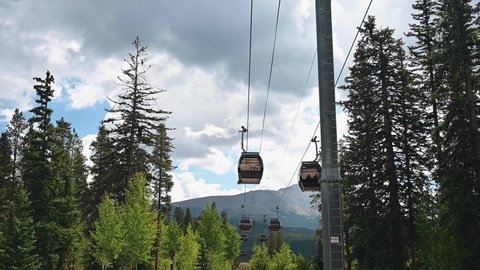 Breckenridge, Colorado  USA – September 4  2021: Breckenridge gondolas carrying tourists up the ski mountain in summer.