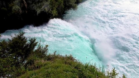 Looking at stunning Huka Falls waterfall mouth with extremely fast flowing water from Waikato River on a short walk in Taupo, New Zealand Aotearoa