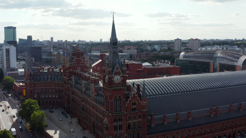 Slide and pan shot of historic brick building in Victorian style. St Pancras train station in Camden borough. London, UK Royalty-Free Stock Footage #1079618615
