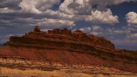 Dreamy cumulus clouds float above Spotted Wolf Canyon in the San Rafael Swell, Utah on an idyllic summer day. - Powered by Shutterstock - Get 15% off with code: PIKWIZARD15