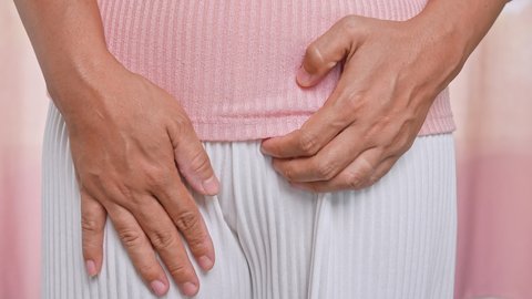 Female hands scratching crotch with leucorrhoea, vaginitis, problems of bacterial vaginosis, vaginal itching and unpleasant smell. Gynecological and health care concept.